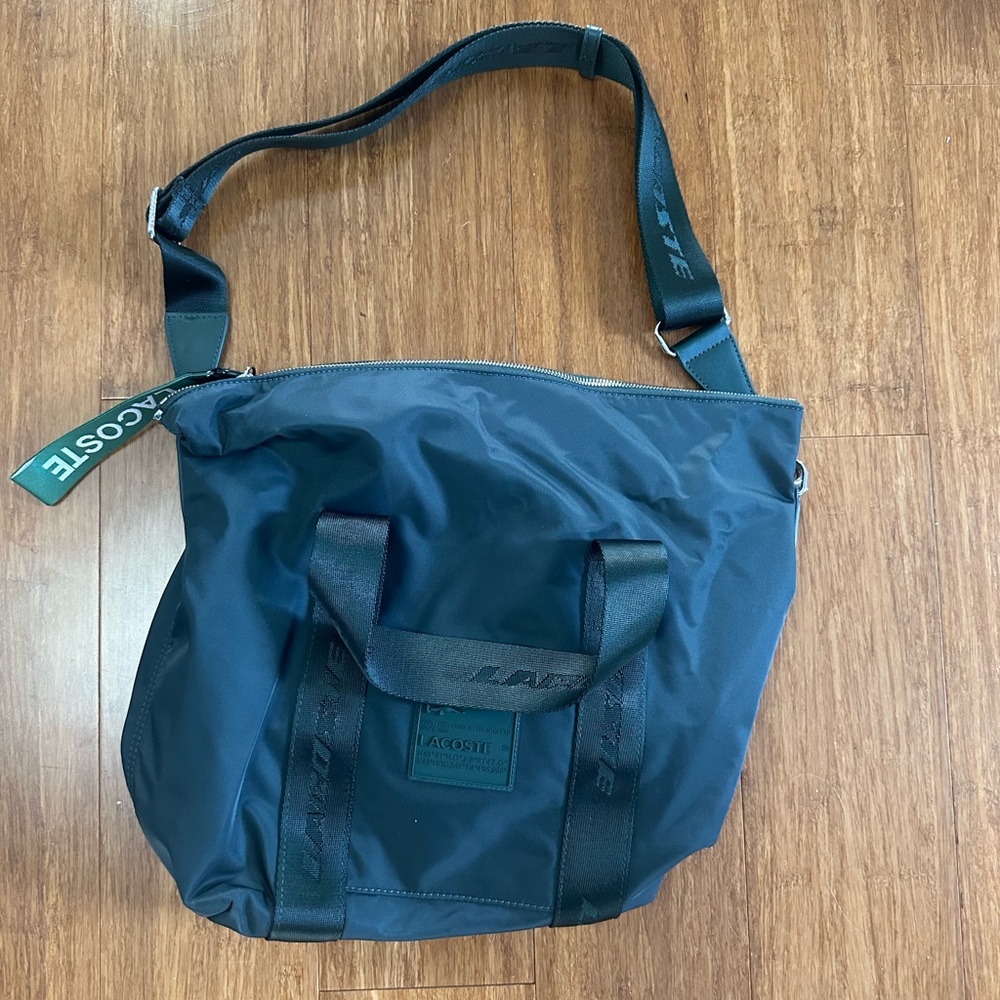 Lacoste Nylon Forest Green bag with 3 pockets and removable long strap. Zipper.